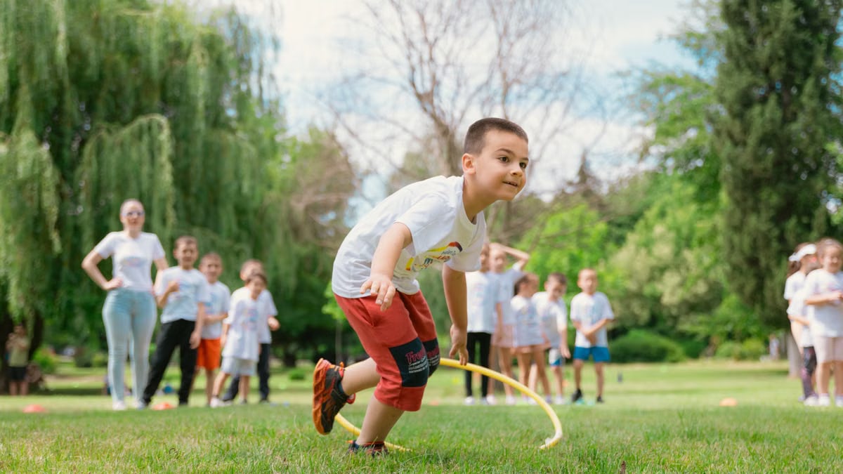 Kids enjoy outdoor fun with hula hoops in a vibrant park setting.